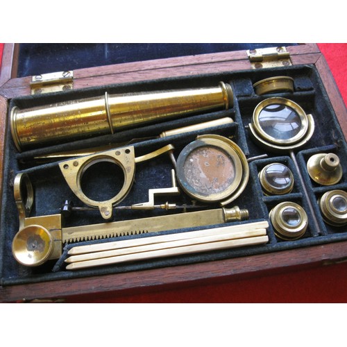 166 - A late 19th century portable brass microscope in a rosewood case, complete, with assorted mirrors an... 