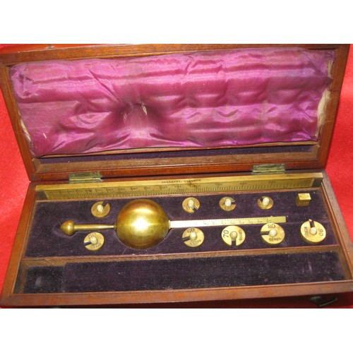 167 - A Sikes's Hydrometer in mahogany case, a cased balance scale by J Nesbitt of Manchester, a wooden wh... 