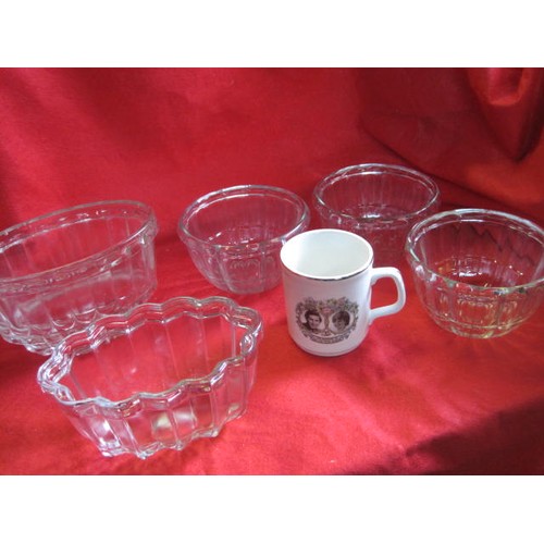 31 - A small collection of vintage glass jelly moulds, plus a commemorative mug