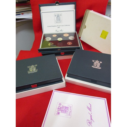 117 - A selection of boxed Royal Mint proof sets in presentation cases for 1986, 1987, 1990 and 1991