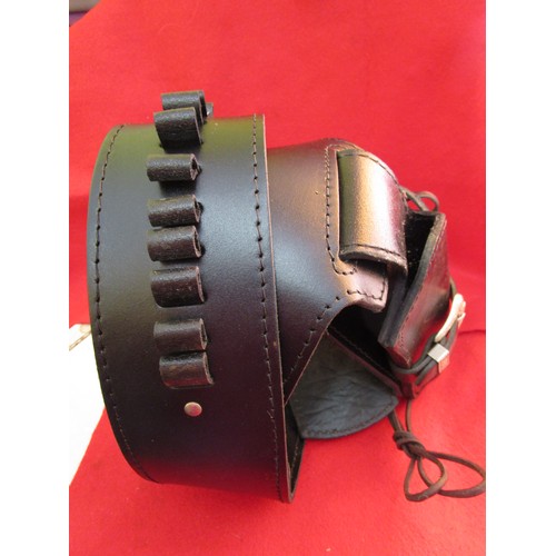 226 - A heavy black leather single gun gunbelt and holster, the holster complete with tie-downs and the be... 