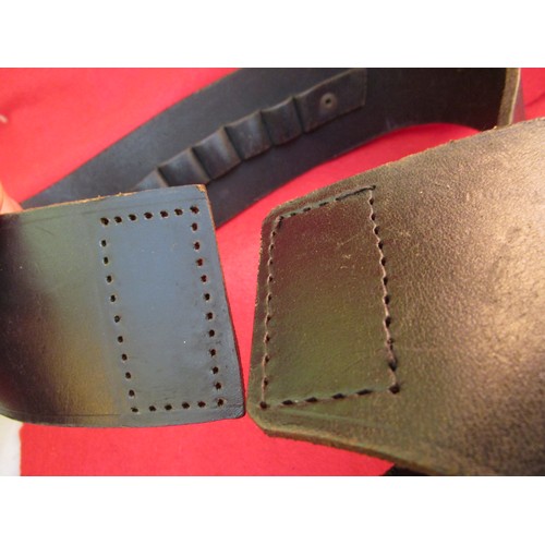 227 - A heavy gunbelt and holster in black leather, in good order except stitching failed at joint and wil... 