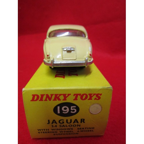 104 - Dinky Jaguar 3.4 saloon #195, boxed, finished in cream with red interior, immaculate.