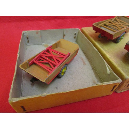 156 - A Dinky Toys trade box of 3 x 27B Harvest Trailers... box good with some marks, trailers have some m... 