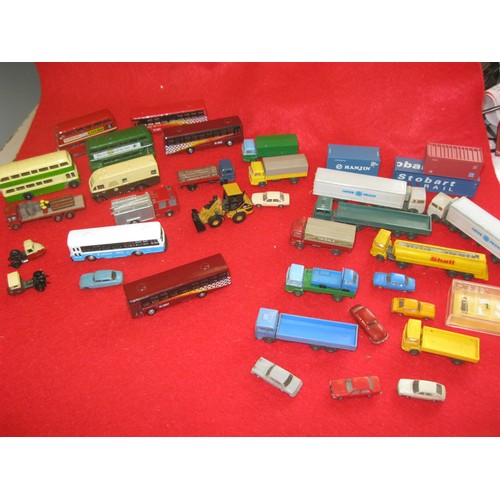 1069 - An assortment of die cast and plastic vehicles for N gauge railway layouts. The buses and items to t... 