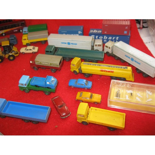 1069 - An assortment of die cast and plastic vehicles for N gauge railway layouts. The buses and items to t... 