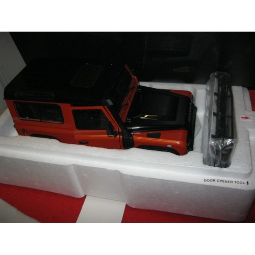 229 - A Kyosho Land Rover Defender 90 Adventure in Orange & Santorini Black, Dealer Model, boxed and mint ... 