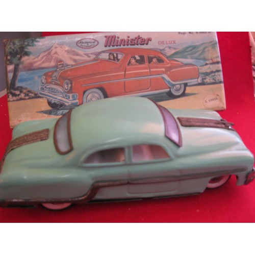 1 - A boxed Minister Delux tin plate car in light green, friction drive, wear to chromed parts but other... 