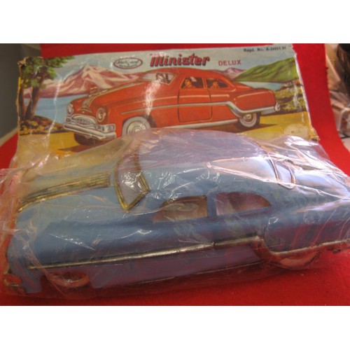 2 - A boxed Minister Delux tin plate car in light blue, friction drive, wear to chromed parts but otherw... 