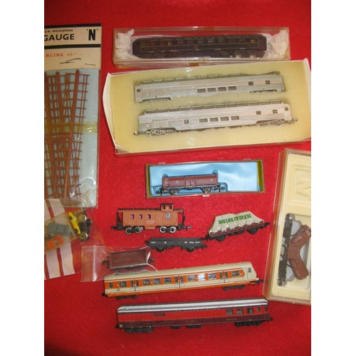 1013 - An assortment of N gauge wagons and coaches by various manufacturers including Arnold, Roco etc plus... 