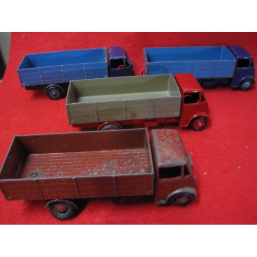 255 - 4 Dinky Guy 4 wheel trucks 2 twin tone Blue 1 twin tone Red and Beige 1 light Brown.
All good with n... 