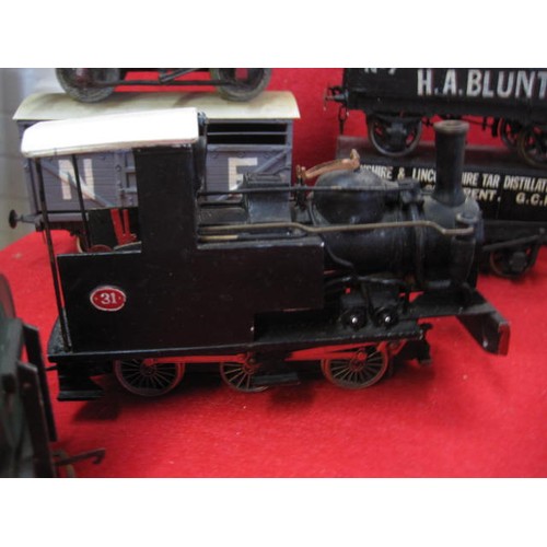 1108 - An O Gauge Tank Engine mounted on OO Gauge running gear, plus a pair of wagons - one a 'Devenish' ta... 