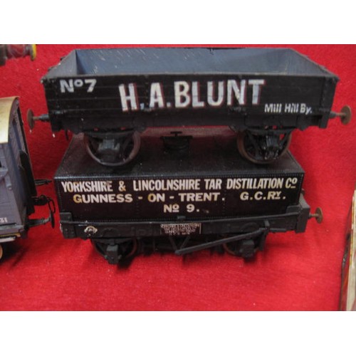 1108 - An O Gauge Tank Engine mounted on OO Gauge running gear, plus a pair of wagons - one a 'Devenish' ta... 