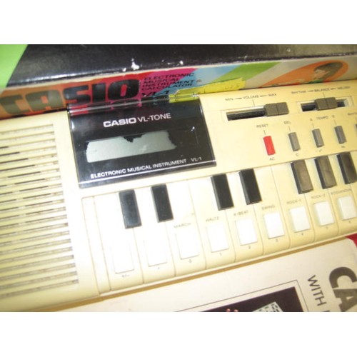 1216 - A vintage Casio VL-Tone Electronic Organ, boxed, with instructions, working order but slight damage ... 