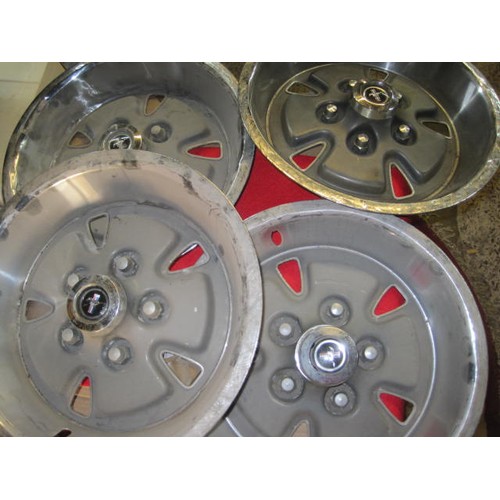 14 - A set of 4 Ford Mustang vintage hub caps in good order with the running pony motif to the centre bos... 