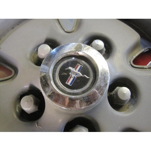 14 - A set of 4 Ford Mustang vintage hub caps in good order with the running pony motif to the centre bos... 