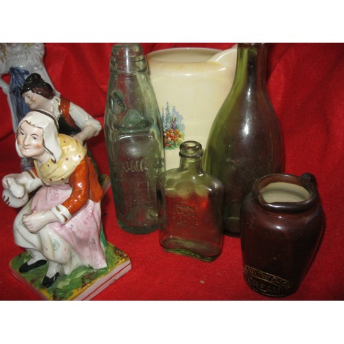 45 - An assortment of glass and china including Victorian figures, bottles and jugs