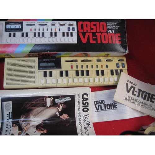 215 - A vintage Casio VL-Tone Electronic Organ, boxed, with instructions, working order but slight damage ... 