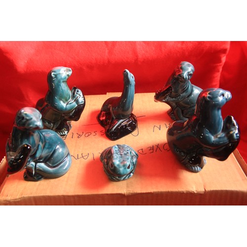 45 - A shelf of Poole Pottery figures including a set of 3 dolphins etc