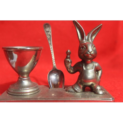 236 - An attractive child's egg-cup stand with rabbit figure and egg-cup, the pair silver plated, with a s... 