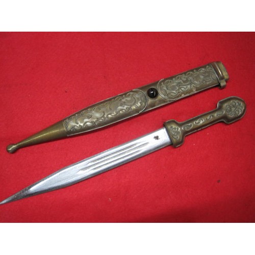 155 - An older reproduction dagger in brass scabbard with 'jewel' mounted to centre, with brass hilt and s... 