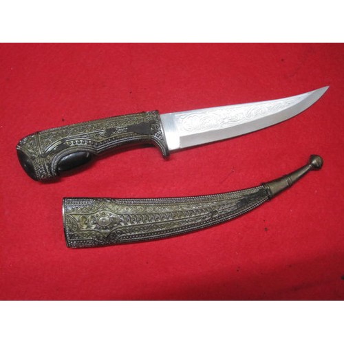 148 - An Arabic-style knife in scabbard, the blade of stainless steel.