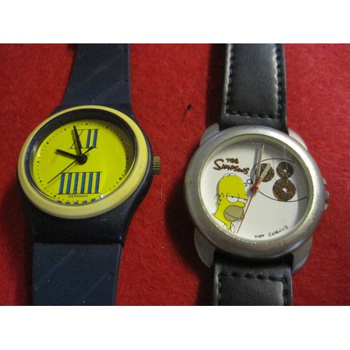 314 - Blue with yellow face hand wind German watch on blue plastic strap, and a Homer Simpson quartz watch... 