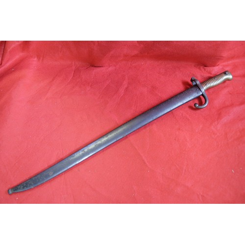 128 - A French Chassepot Bayonet in scabbard in very good order, the blade greased and inscribed 1879, mat... 