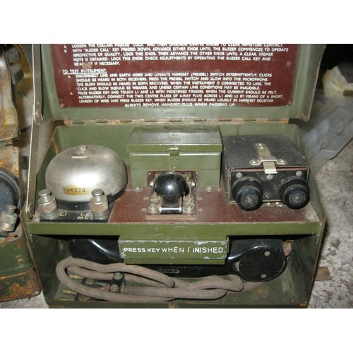 146 - A pair of vintage military field telephones, one with morse key