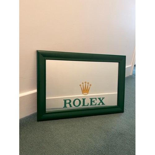 122 - A 350mm x 500mm mirror bearing 'Rolex' branding