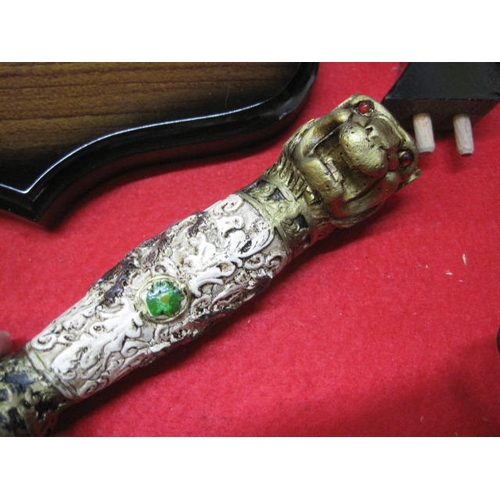 144 - A new and boxed ornate 'Lion Knife' with stand