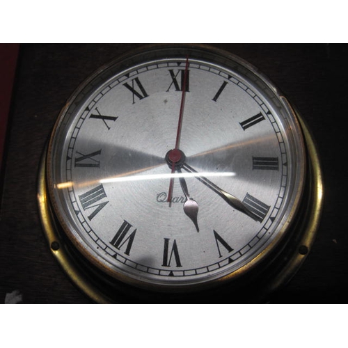 140 - A bulkhead-style brass cased quartz clock and a matching brass cased Weathermaster barometer both mo... 