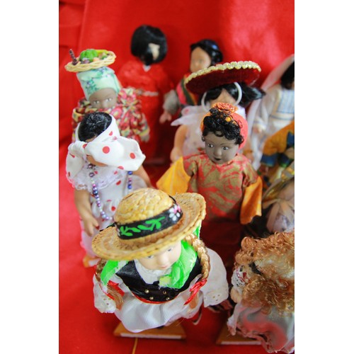 29 - A collection of 'Dolls of the World', plus stands