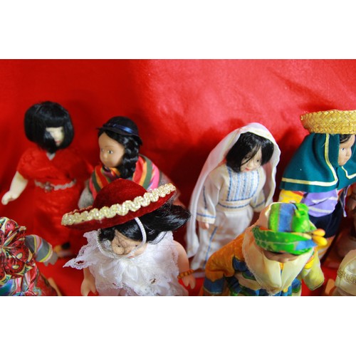 29 - A collection of 'Dolls of the World', plus stands