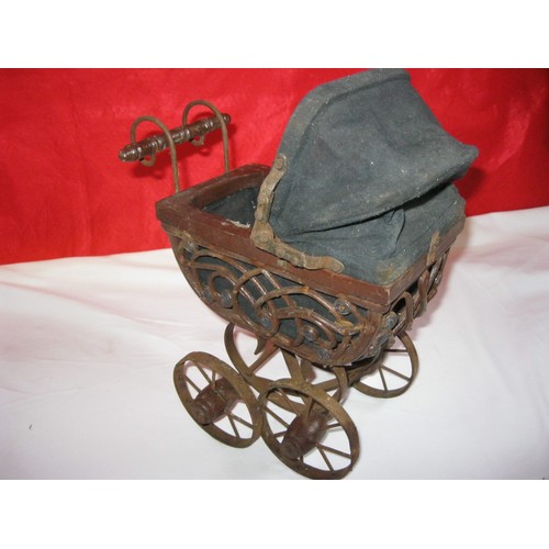 204 - An antique toy pram, believed to be French and Victorian