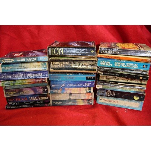 7 - A crate of mainly science fiction novels by authors such as Robert Heinlein, Colin Wilson, etc, all ... 