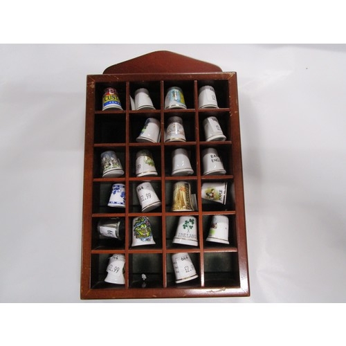 12 - A selection of thimbles in a Display case approx 6 inches by 8 inches in a dark brown wood finish di... 