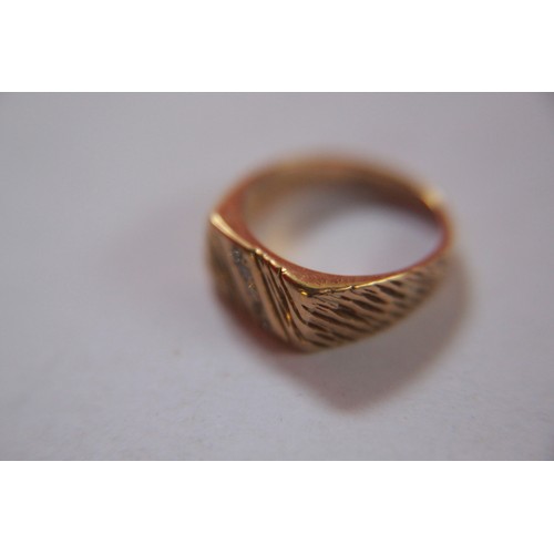 166 - A gentleman's dress ring in 9ct gold, hallmarked for London, with diamonds to face, total approximat... 