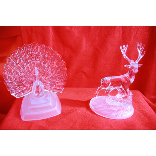 58 - A selection of  glass figurines including a Peacock, Eagle, Elephant, Giraffe and a Stag