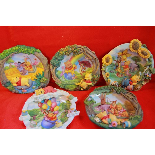 79 - 9 wall hanging plates with raised Disney figures inluding Winnie the Pooh