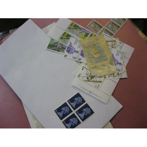 144 - A folder of mint UK stamps including several complete and partially complete sheets of unused stamps