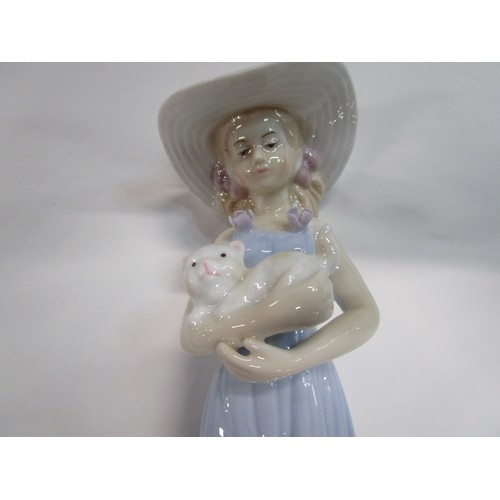 22 - A boxed figurine of a young lady holding a Cat.

The figurine is from the Porcelain Collection exclu... 