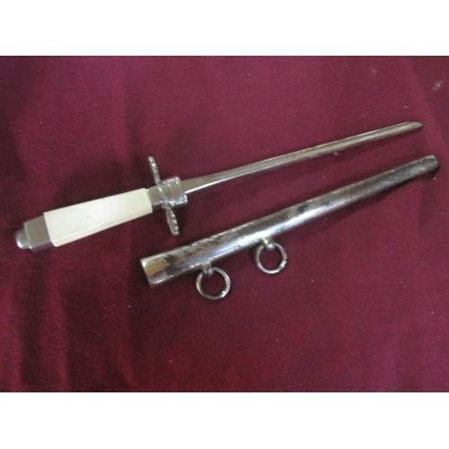 59 - A ceremonial type dagger in sheath with belt hanging hoops and a white handle