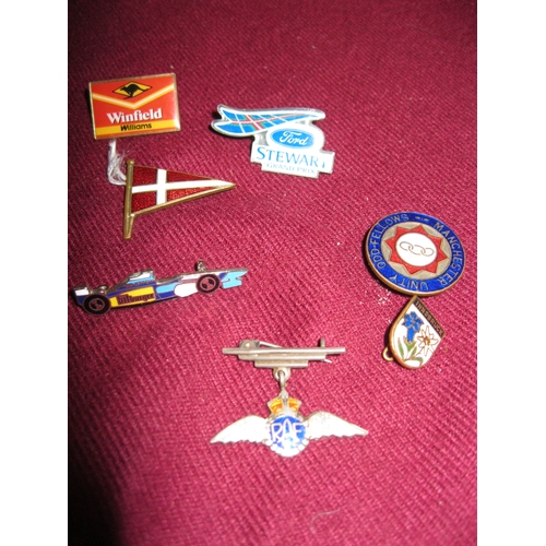 83 - A small assortment of badges including Stewart Ford, Benetton and Winfield Williams Formula 1 badges... 