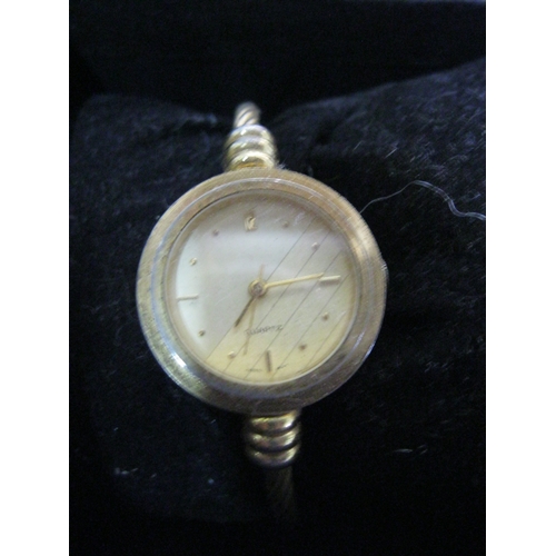 101 - A pair of ladies watches, the gold coloured one on a torque-style strap, both require batteries