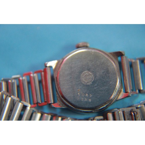 144 - A West End Watch Co military trench watch and strap, the rear marked with the government inverted ar... 