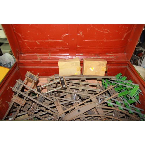 198 - A large metal storage trunk containing O gauge track and accessories including points, engine shed, ... 