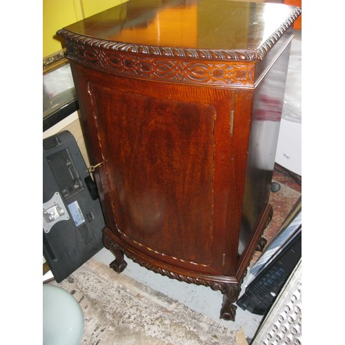 89 - An antique music cabinet with scrolled decoration and cabriole legs resting on claw and ball feet, w... 