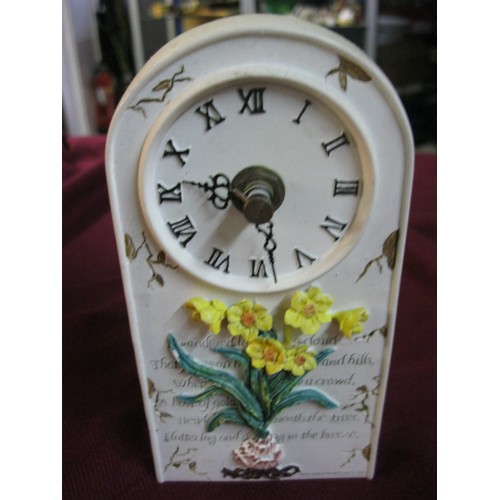 39 - Resin battery operated clock approx 6 inches tall by three wide.
Raised decoration to the front with... 