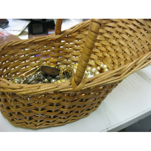 175 - A carafe basket of costume jewellery